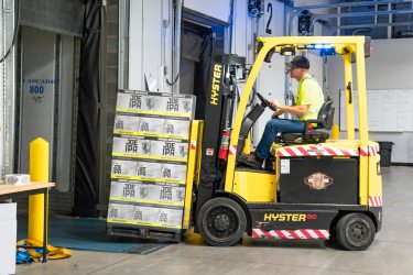 Elevate_main-riding-a-yellow-forklift-with